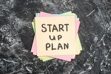 Wall Mural - top view start up plan note on sticker on a gray background lesson student note paper study sticker 