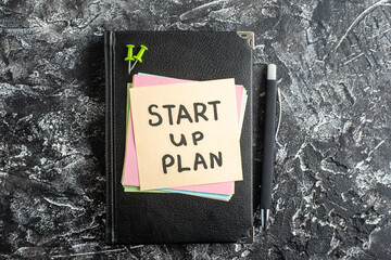 Wall Mural - top view start up plan note on sticker with copybook on gray background lesson student note notepad 