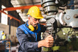 © chokniti - professional technician engineer with safety helmet hard hat working in industrial manufacturing factory, men at work to checking equipment of machinery production technology or construction operating