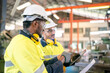 © chokniti - professional technician engineer with safety helmet hard hat working in industrial manufacturing factory, men at work to checking equipment of machinery production technology or construction operating