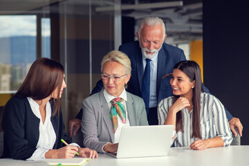 Wall Mural - Mature businessman leader mentor talking to diverse colleagues team listening to caucasian ceo.