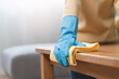 © Pormezz - happy Female housekeeper service worker wiping table surface by cleaner product to clean dust.
