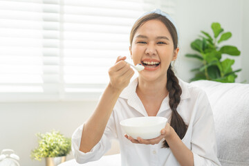 Wall Mural - Diet, Dieting pretty attractive asian young woman, girl use fork at lettuce on mix vegetables, green salad bowl, eat food is low fat to good body. Nutritionist female, Weight loss for healthy person.