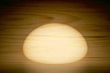 Wall Mural - 3d scene background with wooden floor illuminated by round spot light