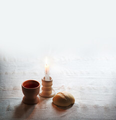 A bowl of wine and bread on the table. Communion symbols