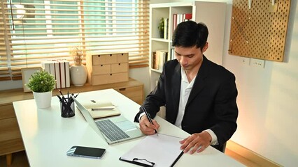 Wall Mural - Professional young businessman using pen signing a contract investment at working desk. Business agreement concept