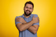 © Andrii Iemelianenko - Come to me, I want to embrace you. Caucasian handsome man spread hands and give hug to you. Pleasant expression, love feelings. Young guy isolated alone on yellow studio background. People lifestyles