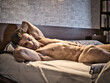 Totally naked sexy man with muscular body on bed