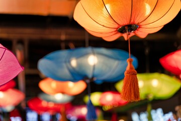 Sticker - Closeup shot of colorful Chinese lamps hanging on a ceiling in a blurred background