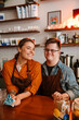 © Drobot Dean - Man with down syndrome and his female colleague smiling while standing at counter in coffee shop