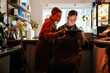 © Drobot Dean - Woman teaching man with down syndrome how to use tablet during internship in cafe