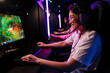 © Drobot Dean - Asian woman gamer playing online video game in cybersport club