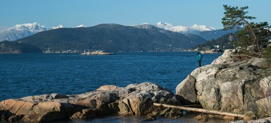 Sticker - Scenic view of a mountain range in the distance with a calm lake in the foreground