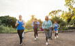 © DisobeyArt - Fit senior people running at city park - Group of elderly friends doing sport workout together outdoor - Main focus on left mature woman face