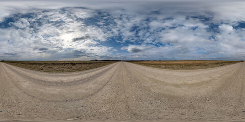Wall Mural - spherical 360 hdri panorama on gravel road with clouds on overcast sky in equirectangular seamless p