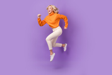 Wall Mural - Full body profile portrait of energetic lady jump rush empty space isolated on purple color background