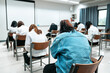 © Education StockPhoto - College students doing examinations in the classroom