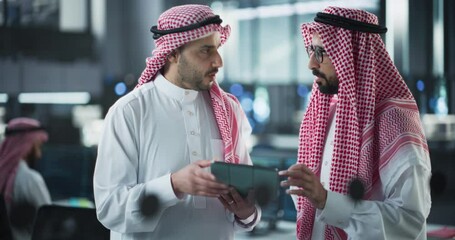 Fototapete - Two Young Muslim Software Engineers Use Tablet Computer to Discuss a Technological Project in a Modern Industrial Office. Arab Scientists Work in Research and Development Center