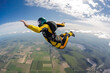 © ADDICTIVE STOCK - Generative AI illustration of brave person in helmet and uniform jumping with parachute above ground against cloudy blue sky