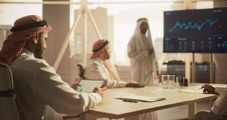 Aufkleber - Muslim Businessman Using a Tablet Computer at a Meeting with Corporate Partners. Manager Getting Familiar with Financial Annual Report while Listening to the Presentation in Conference Room