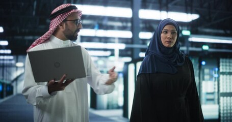 Poster - Middle Eastern Computer Engineer and Cybersecurity Specialist Work in Server Facility. Muslim Female and Male Managers Talk, Perform System Maintenance Check with Laptop Computer