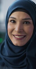 Poster - Vertical Screen: Portrait of a Middle Eastern Female Using Computer, Looking at Camera and Smiling. Empowered Muslim Information Technology Specialist, Software Engineer, Developer or Data Scientist