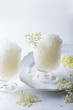 Elderflower lemonade or champagne granita with freshly picked elderberry flowers. Granita dessert with elderflower cordial syrup