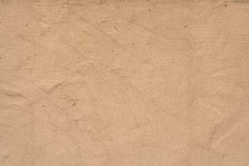 Old traditional house wall texture. Brown beige sandy color rough plaster background.