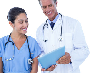 Smiling male doctor with nurse using digital tablet