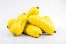 A Group Of Yellow Gourds With One Small Pear On The Top.