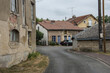 asphalt street of the North France village Romagne sous Mont Foucon with typical houses and black car