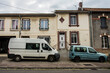 cars in front of typical, connected houses in the Northern part of France in the village Romagne sous Montfoucon