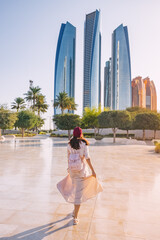 Wall Mural - Revel in the beauty of Abu Dhabi's breathtaking architecture and multicultural vibrancy, embodied by the elegant figure of an Indian woman.