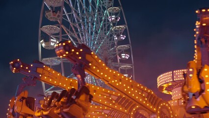 Wall Mural - Ferris wheel. People having fun riding roller coaster at the amusement park at night