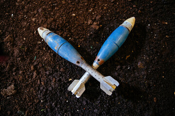 Unexploded mortar mines on ground. War actions aftermath