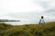 © Designpics - Woman Sitting and Looking into the Distance at the Beach, Camaret-sur-Mer, Crozon Peninsula, Finistere, Brittany, France