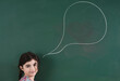 © Designpics - Girl in front of Chalkboard with Speech Bubble in Classroom