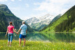 © Designpics - Couple Hiking by Lake, Vilsalpsee, Tannheim Valley, Tyrol, Austria