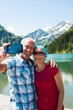 © Designpics - Mature man and woman taking a picture of themselves, Lake Vilsalpsee, Tannheim Valley, Austria