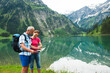 © Designpics - Mature couple looking at map, hiking in mountains, Lake Vilsalpsee, Tannheim Valley, Austria