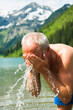 © Designpics - Mature Man Splashing Water on Face, Vilsalpsee, Tannheim Valley, Tyrol, Austria
