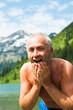 © Designpics - Mature Man Splashing Water on Face, Vilsalpsee, Tannheim Valley, Tyrol, Austria