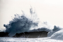 Dramatic Wave Crashing Against The Rocks Along The Coast Of Iceland; Atlantic Ocean, Iceland