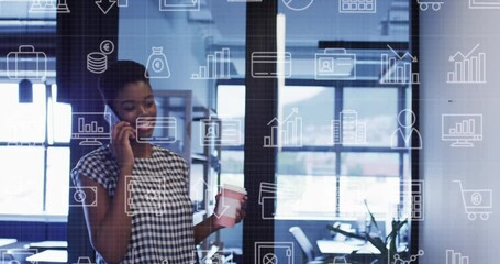 Wall Mural - Animation of currency symbols over african american businesswoman talking on smartphone at office