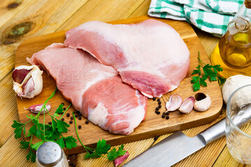 Wall Mural - Raw slice of Iberian pork secret and parsley on kitchen board