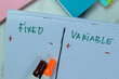 © syahrir - Concept of Fixed and Variable write on book isolated on Wooden Table.