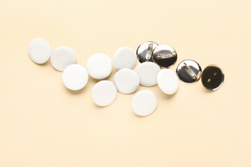 Blank white badges on beige background