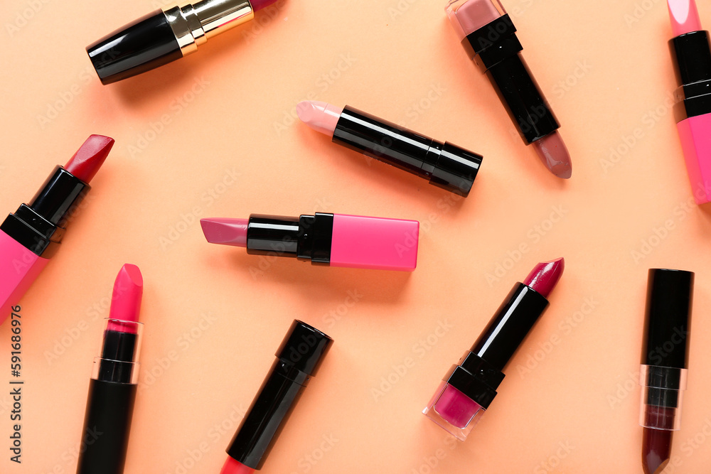 Set of different lipsticks on color background