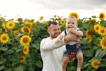 Wall Mural - Cute family playing in a summer field