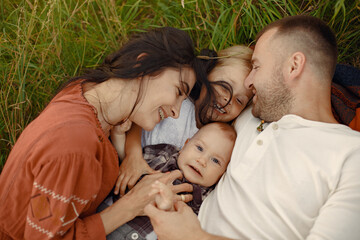 Wall Mural - Cute family playing in a summer field